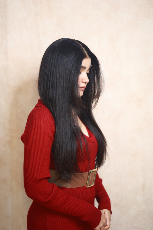 Model wearing GIGI 20-inch natural black wavy human hair wig with HD lace, glueless and clipless design, free parting, and breathable construction for all-day comfort