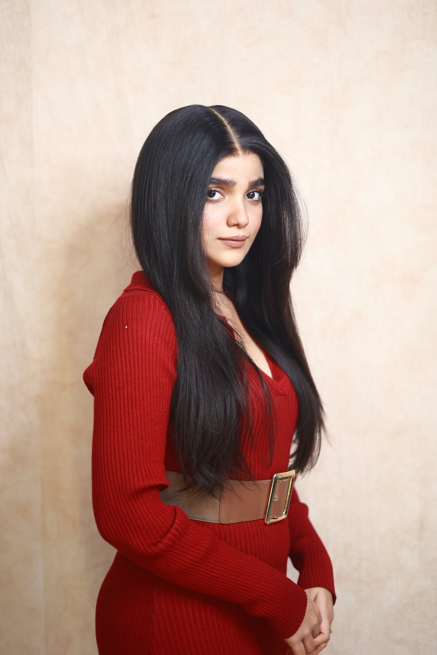 Model wearing GIGI 20-inch natural black wavy human hair wig with HD lace, glueless and clipless design, free parting, and breathable construction for all-day comfort