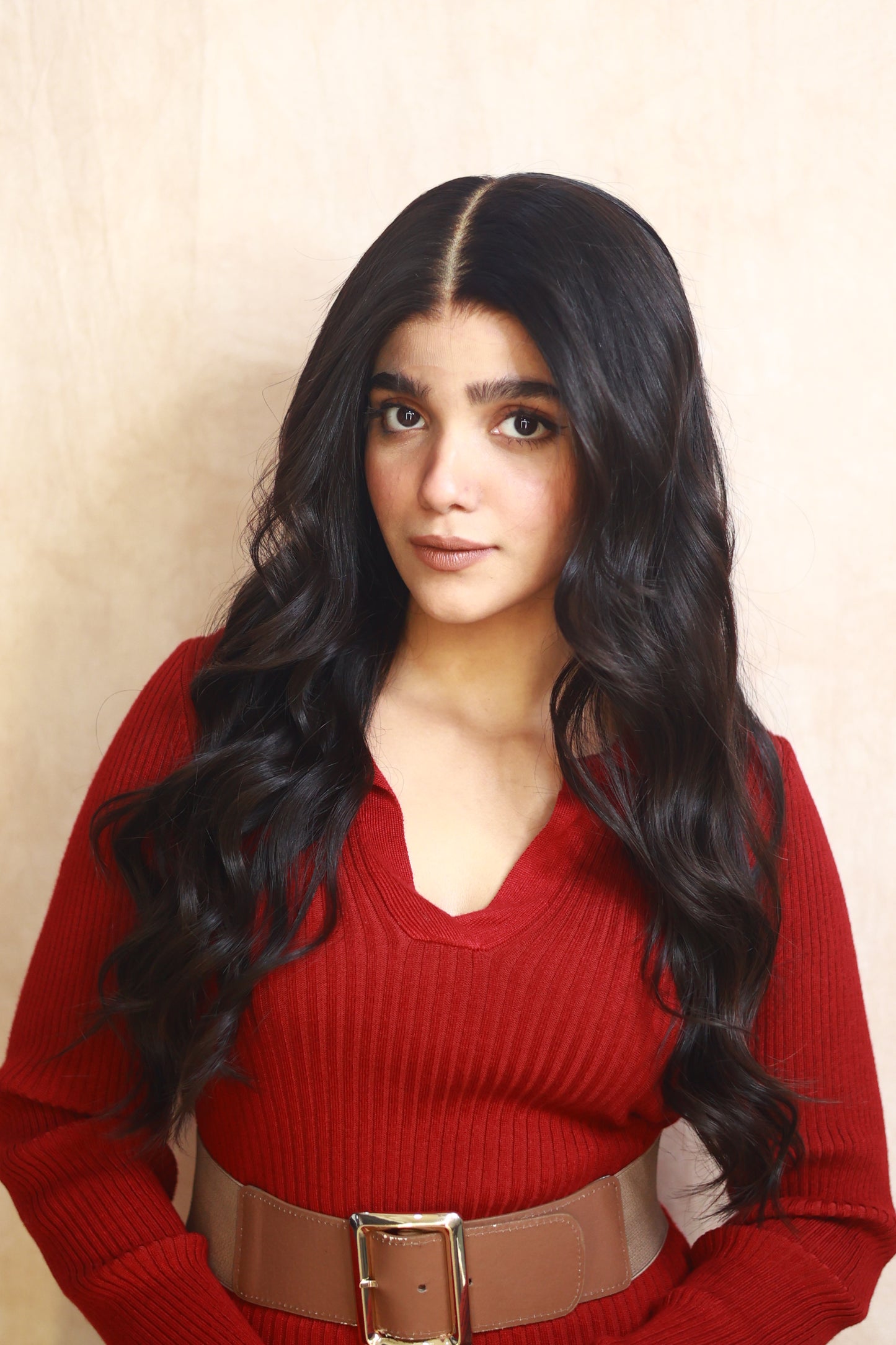 Model wearing GIGI 20-inch natural black wavy human hair wig with HD lace, glueless and clipless design, free parting, and breathable construction for all-day comfort