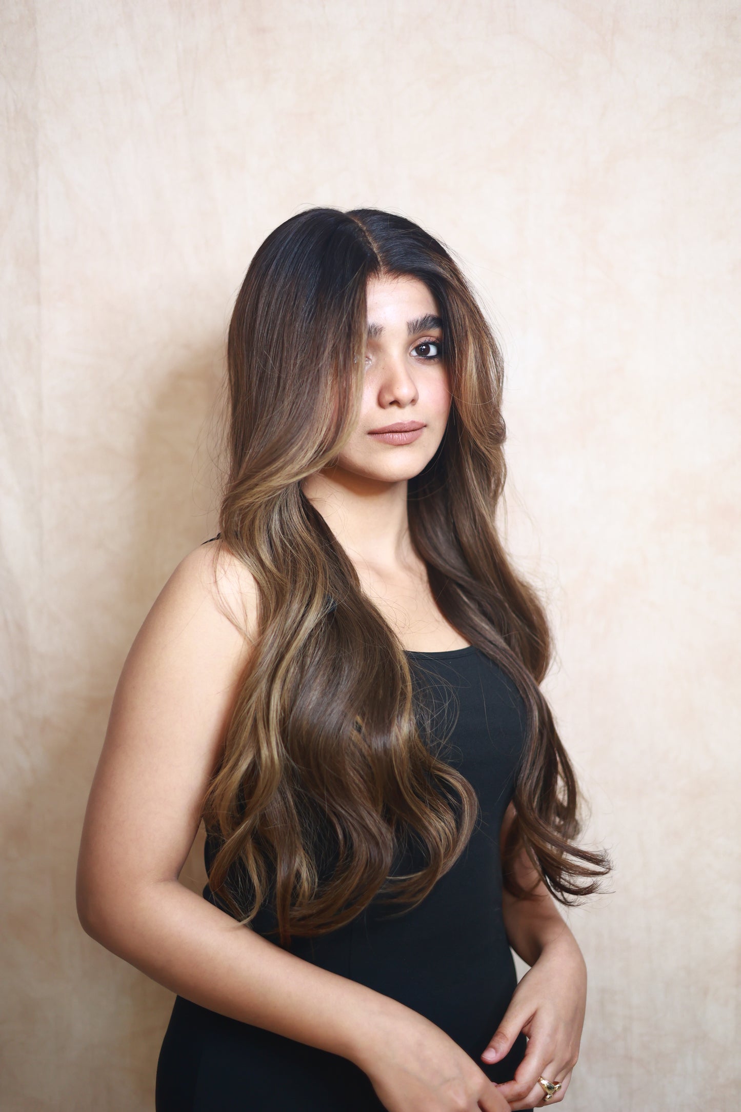 Model wearing SOPHIA 22-inch long wavy human hair wig with balayage, HD lace, glueless and clipless design, free parting, and breathable construction for all-day comfort; premium quality