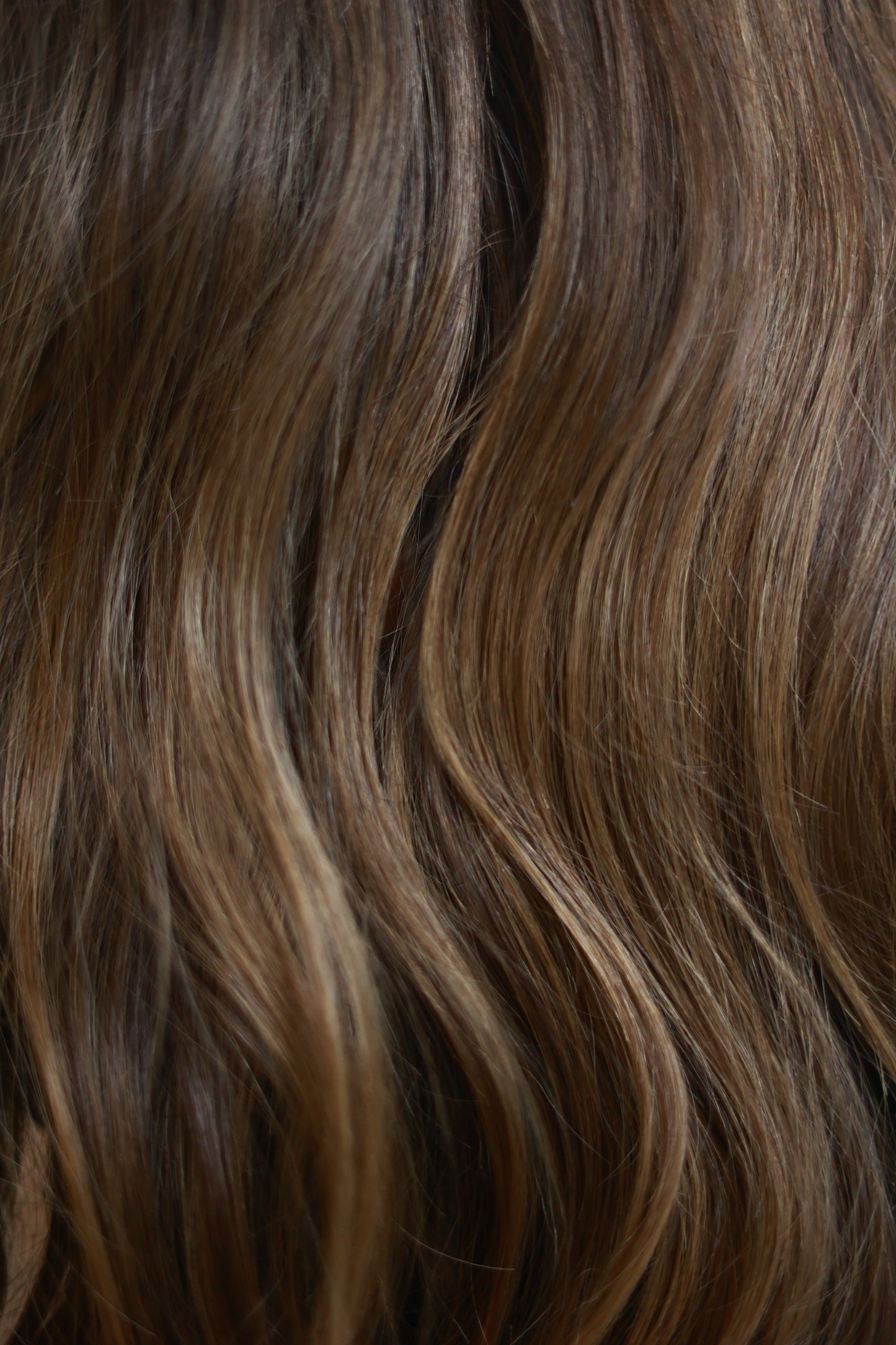 Model wearing SOPHIA 22-inch long wavy human hair wig with balayage, HD lace, glueless and clipless design, free parting, and breathable construction for all-day comfort; premium quality