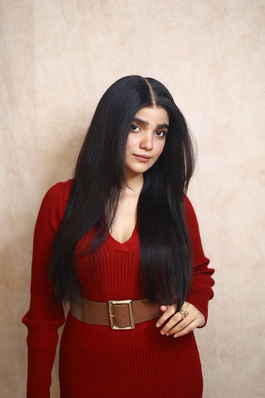 Model wearing GIGI 20-inch natural black wavy human hair wig with HD lace, glueless and clipless design, free parting, and breathable construction for all-day comfort