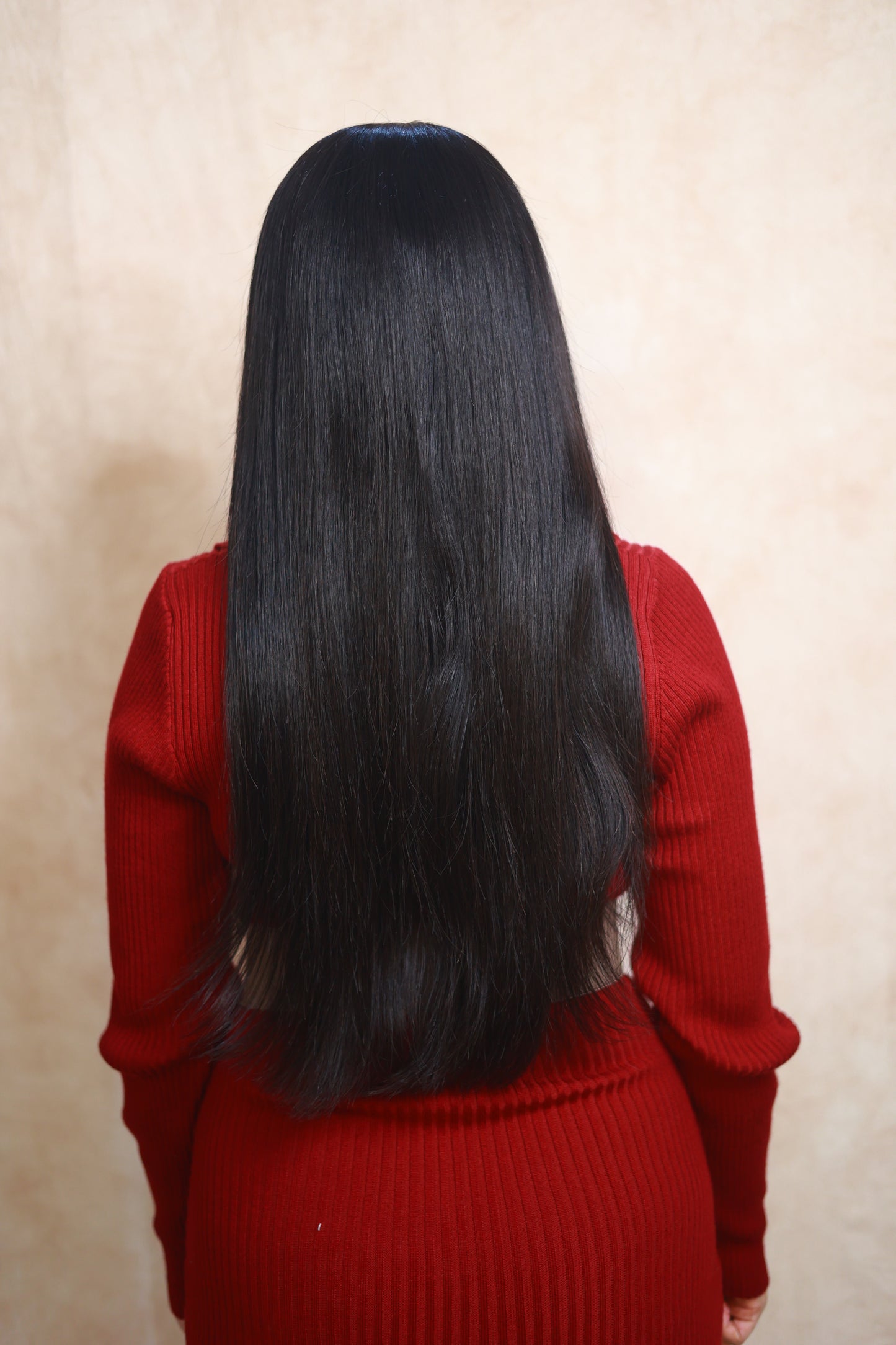 Model wearing GIGI 20-inch natural black wavy human hair wig with HD lace, glueless and clipless design, free parting, and breathable construction for all-day comfort