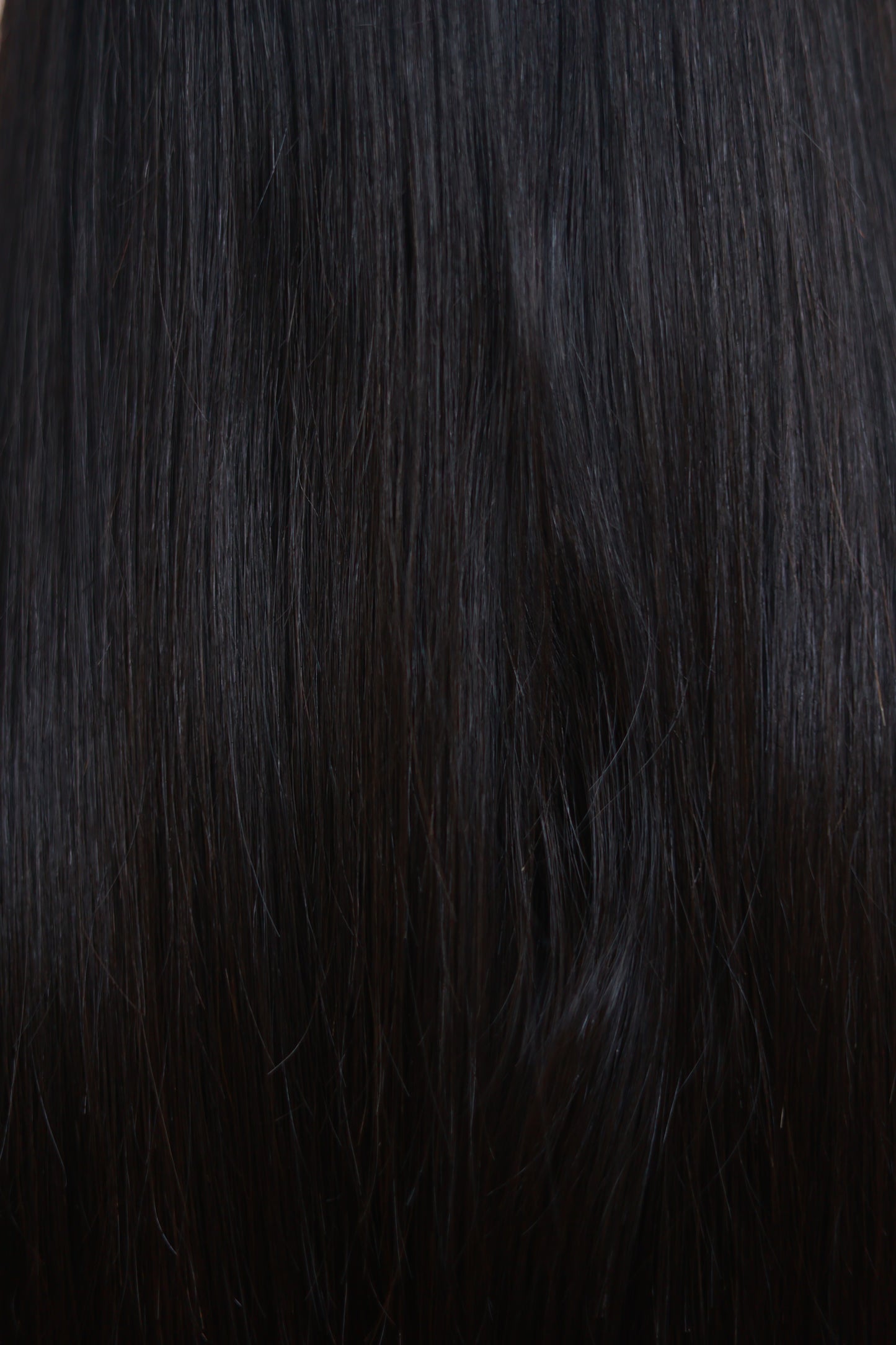 Model wearing GIGI 20-inch natural black wavy human hair wig with HD lace, glueless and clipless design, free parting, and breathable construction for all-day comfort