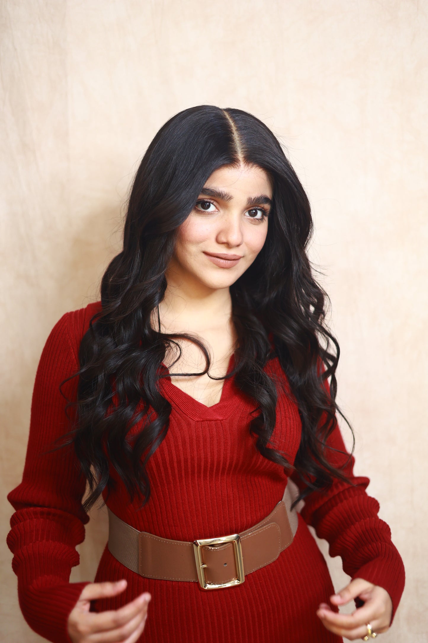 Model wearing GIGI 20-inch natural black wavy human hair wig with HD lace, glueless and clipless design, free parting, and breathable construction for all-day comfort