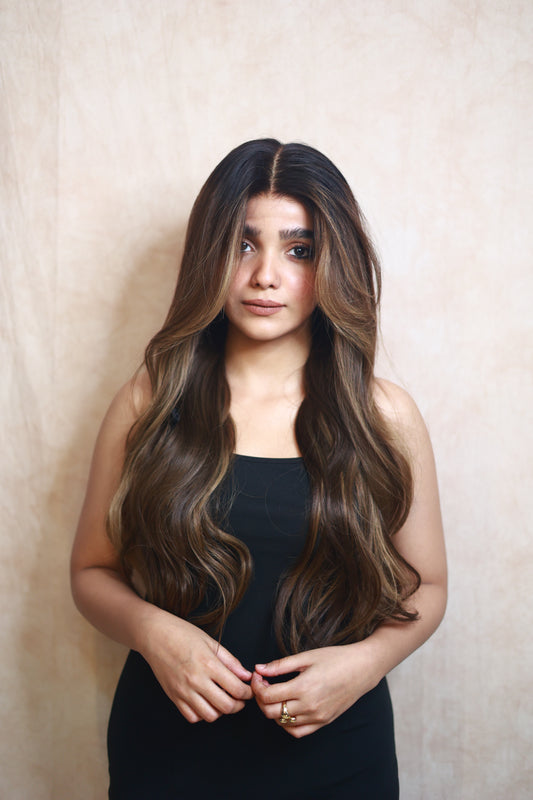 Model wearing SOPHIA 22-inch long wavy human hair wig with balayage, HD lace, glueless and clipless design, free parting, and breathable construction for all-day comfort; premium quality