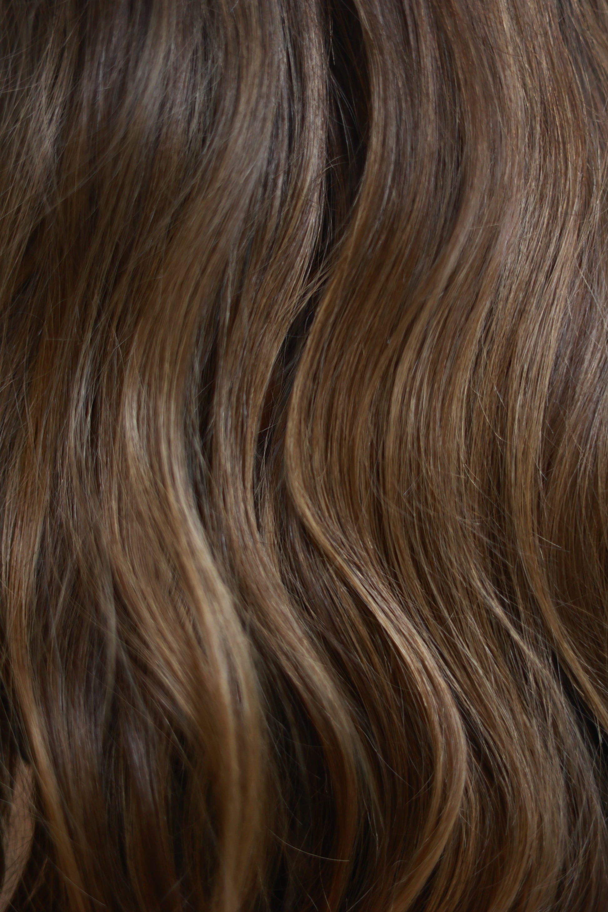 Model wearing SOPHIA 22-inch long wavy human hair wig with balayage, HD lace, glueless and clipless design, free parting, and breathable construction for all-day comfort; premium quality