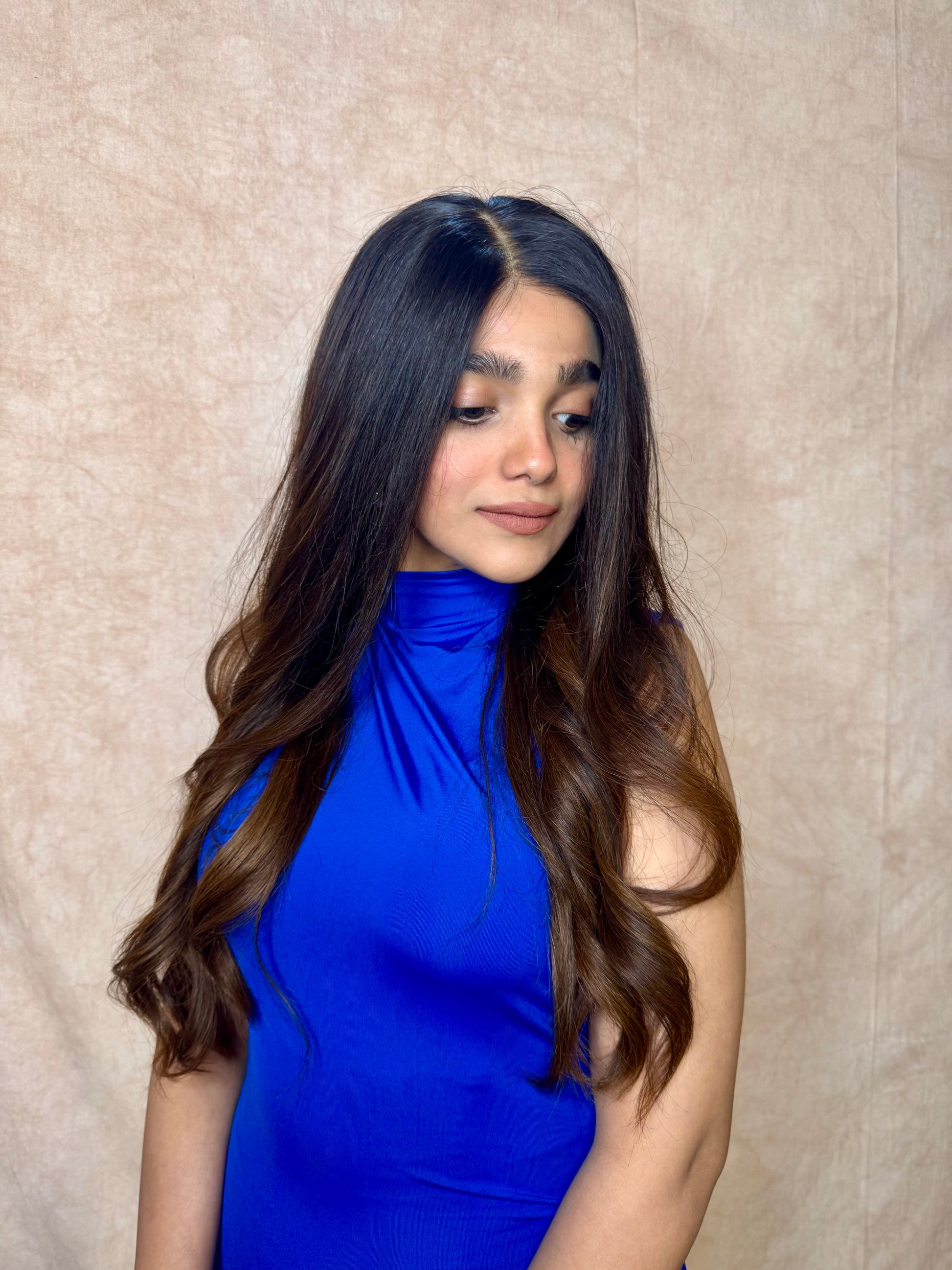 Model wearing AMBER dark brown wavy human hair wig with HD lace, glueless and clipless design, and free parting