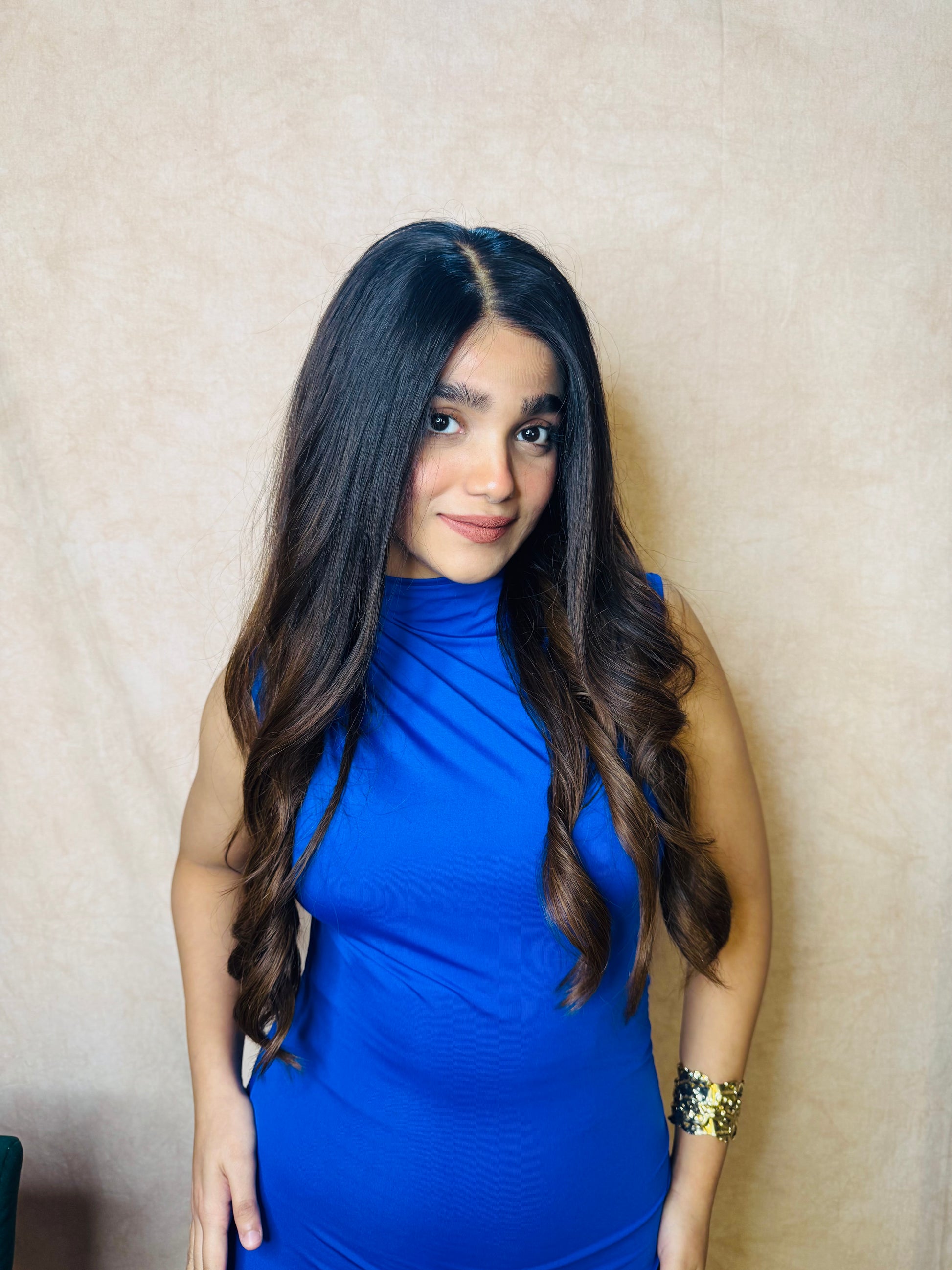 Model wearing AMBER dark brown wavy human hair wig with HD lace, glueless and clipless design, and free parting