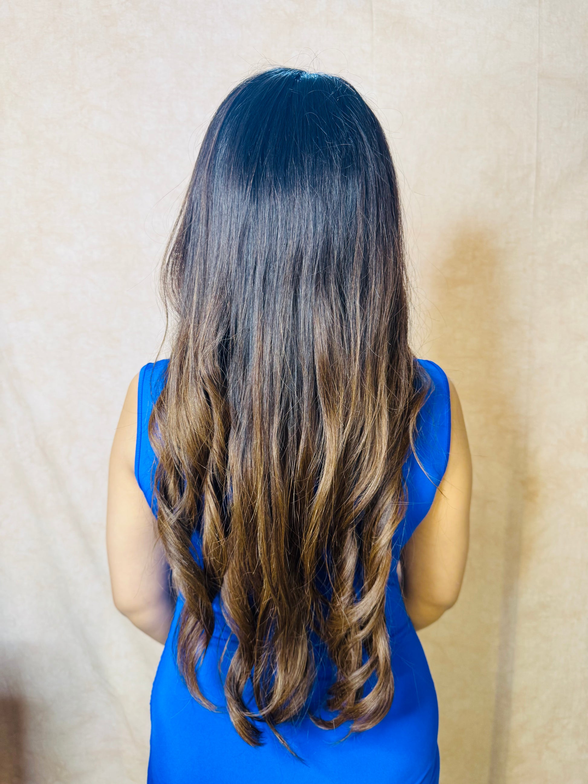 Model wearing AMBER dark brown wavy human hair wig with HD lace, glueless and clipless design, and free parting