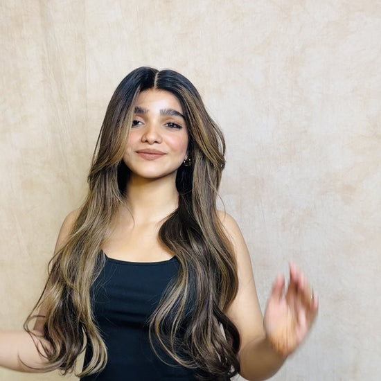 Model wearing SOPHIA 22-inch long wavy human hair wig with balayage, HD lace, glueless and clipless design, free parting, and breathable construction for all-day comfort; premium quality